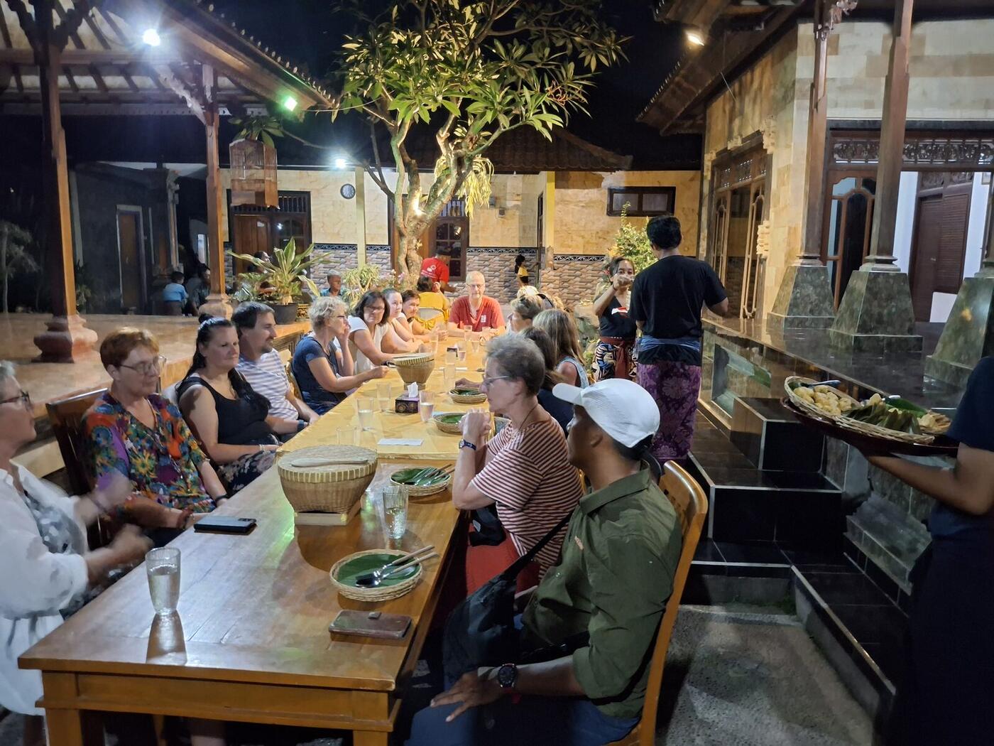 Long-table family dinner under a traditional pavilion